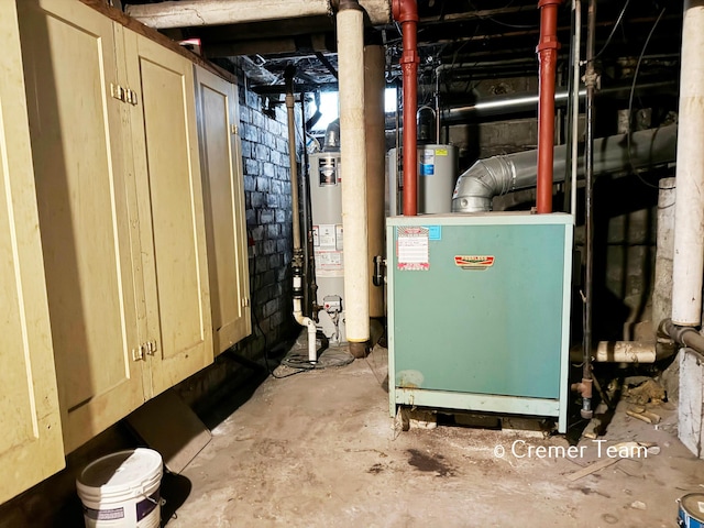 utility room with gas water heater and water heater