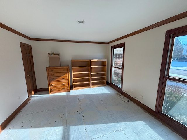 empty room featuring crown molding