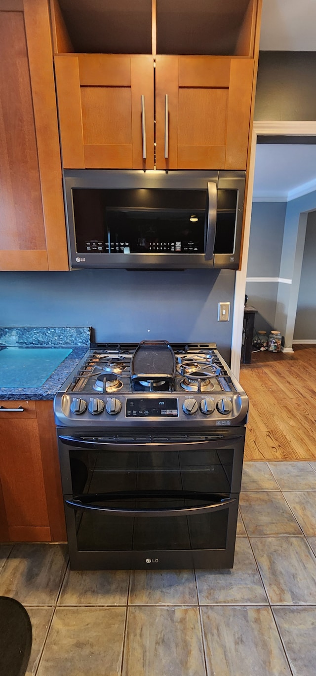 kitchen with tile patterned flooring and appliances with stainless steel finishes