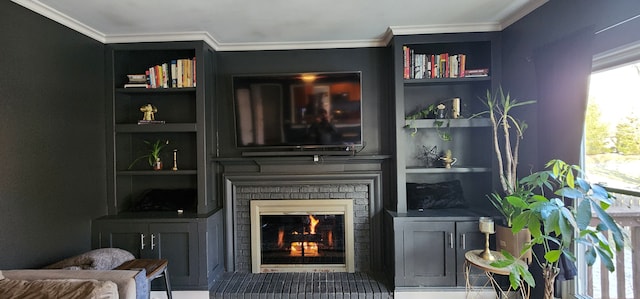 living room with ornamental molding, a brick fireplace, and built in features