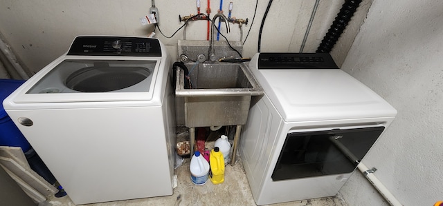 laundry room featuring sink and washer and dryer