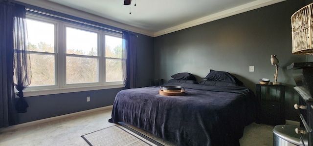 bedroom featuring crown molding, light carpet, and ceiling fan