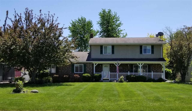 view of front of property with a front yard and covered porch