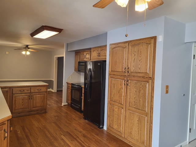 kitchen featuring black appliances, dark hardwood / wood-style floors, and ceiling fan