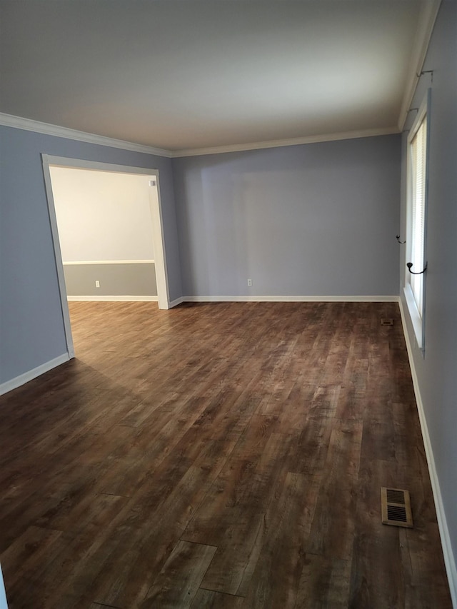 empty room with ornamental molding and dark hardwood / wood-style flooring