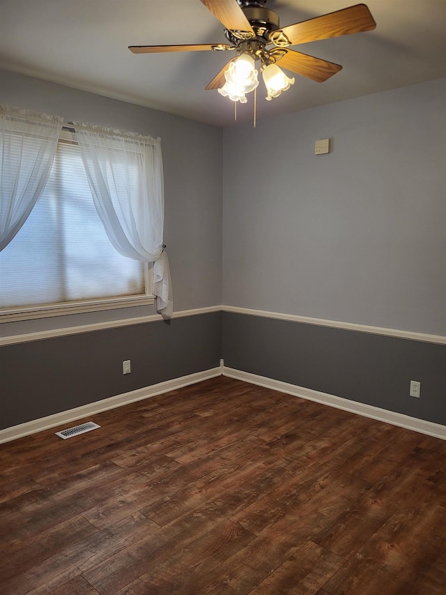 spare room with dark hardwood / wood-style floors and ceiling fan