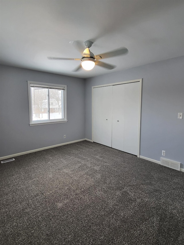 unfurnished bedroom featuring a closet, ceiling fan, and carpet