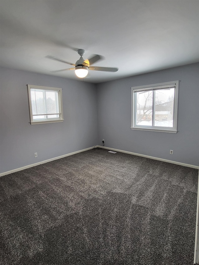 spare room featuring carpet floors and ceiling fan