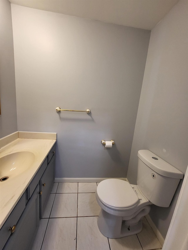 bathroom featuring tile patterned flooring, vanity, and toilet