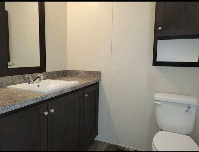 bathroom with vanity and toilet