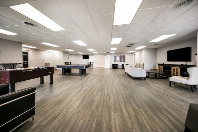 playroom with wood-type flooring and a drop ceiling