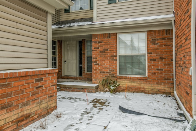 view of snow covered property entrance