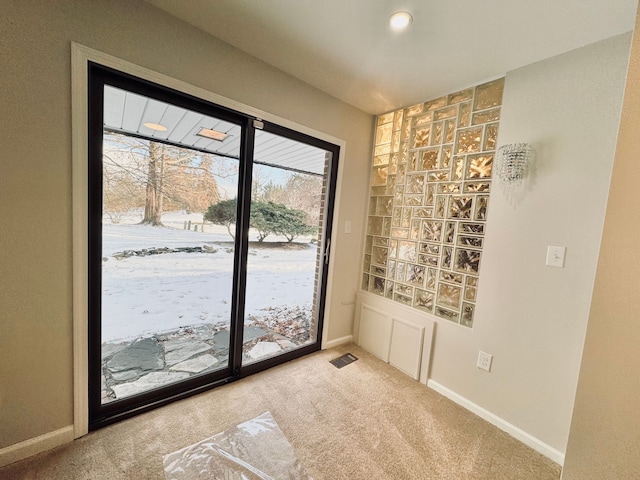 doorway to outside featuring light colored carpet