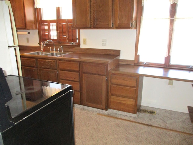 kitchen with sink, black range with electric stovetop, and white refrigerator