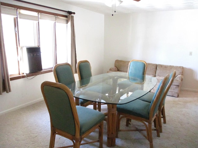 carpeted dining space with ceiling fan and a healthy amount of sunlight