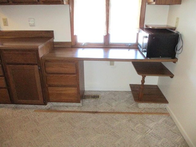 kitchen featuring light carpet