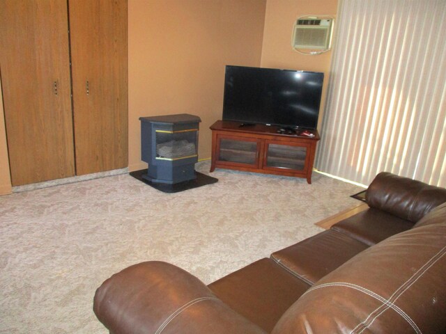 living room with a wall mounted AC and light carpet