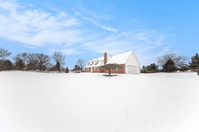 yard covered in snow featuring a garage