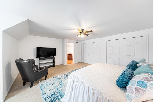 carpeted bedroom with two closets and ceiling fan