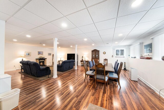 dining area with dark hardwood / wood-style floors and ornate columns