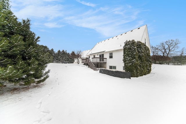 view of snow covered exterior with a wooden deck