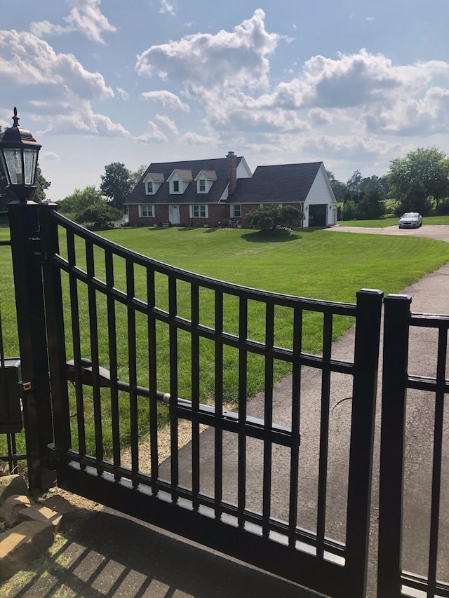 view of gate featuring a lawn