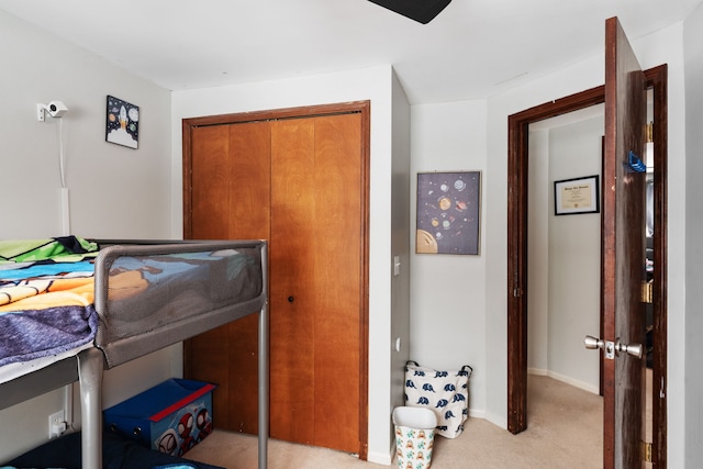 bedroom with light colored carpet and a closet