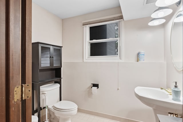 bathroom featuring sink, tile patterned floors, and toilet