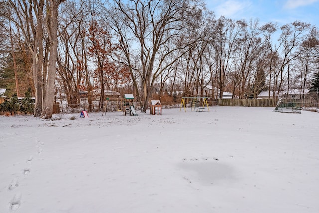 snowy yard with a playground