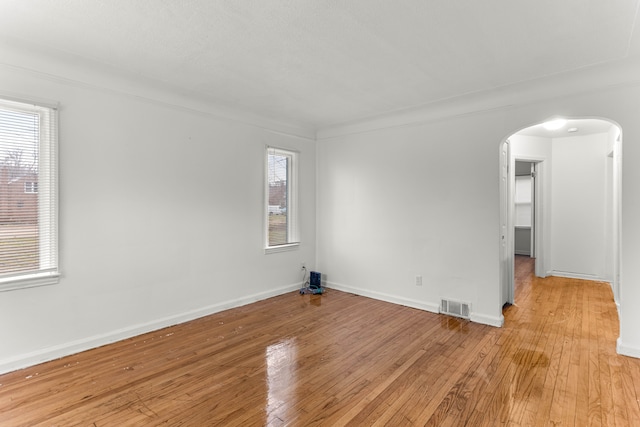 unfurnished room with ornamental molding and light hardwood / wood-style floors