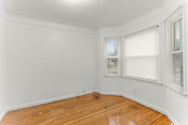 spare room with wood-type flooring