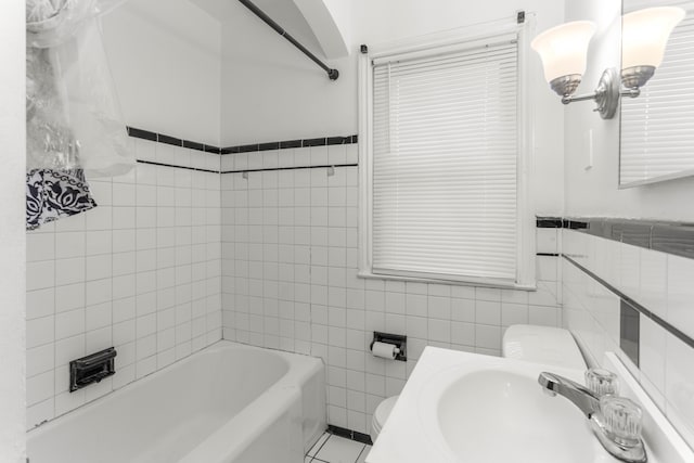 full bathroom featuring sink, tile walls, tile patterned floors, and toilet