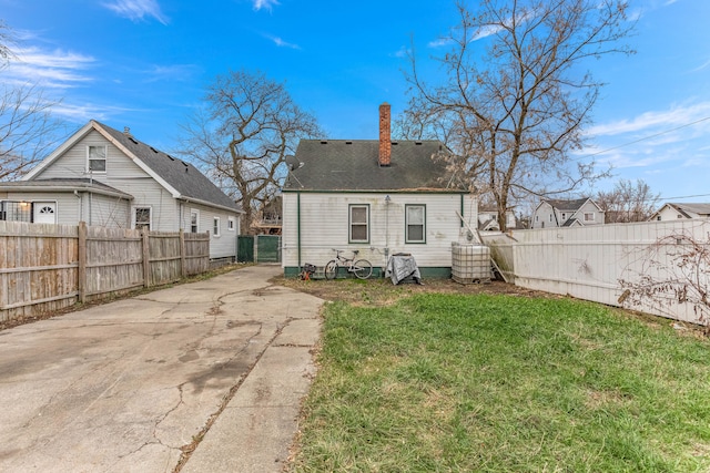 rear view of house with a yard