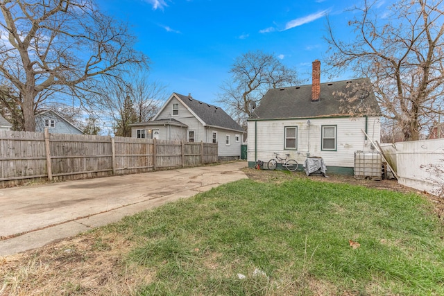 rear view of property with a yard