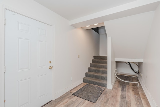 stairway with hardwood / wood-style floors