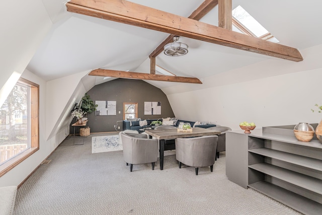 interior space with vaulted ceiling with skylight and light carpet