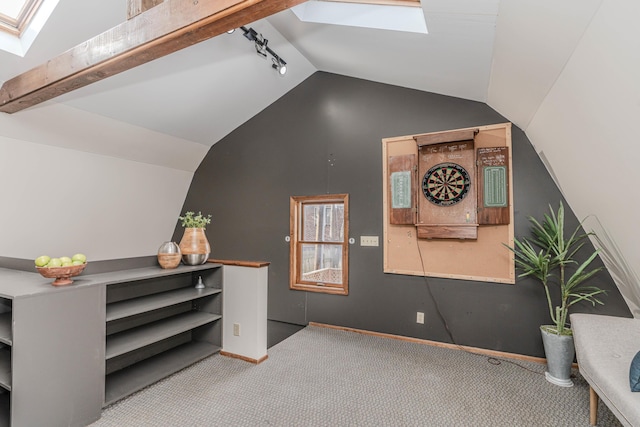 interior space featuring light colored carpet and lofted ceiling with skylight