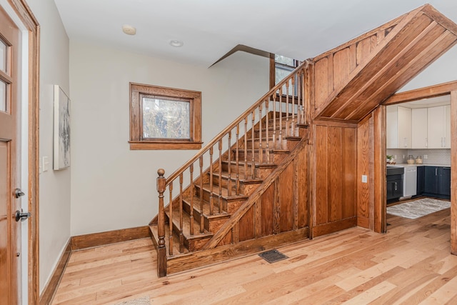 stairs with hardwood / wood-style floors