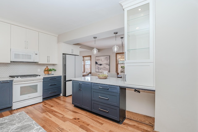 kitchen with white cabinetry, white appliances, and light wood-type flooring