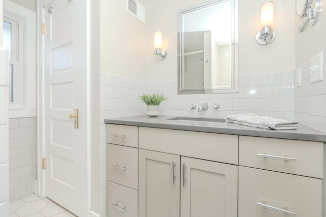 bathroom featuring tile walls, vanity, and tile patterned flooring