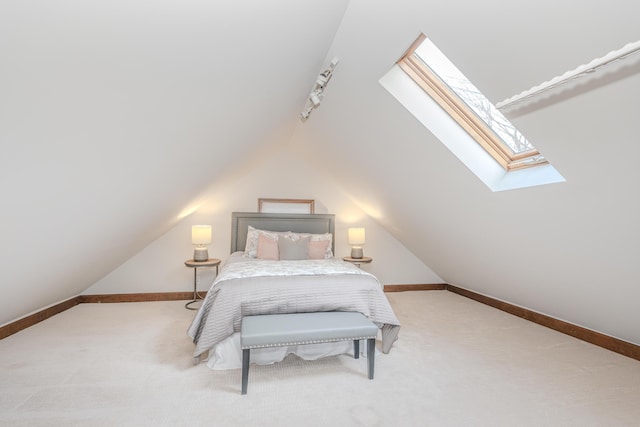 bedroom with vaulted ceiling, track lighting, and carpet floors