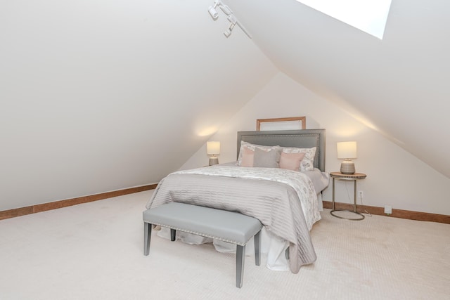 carpeted bedroom featuring lofted ceiling