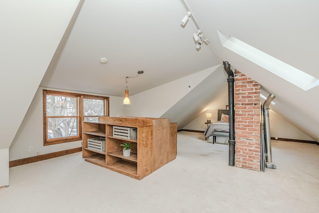 bonus room featuring lofted ceiling with skylight, carpet, and a wood stove