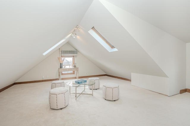 additional living space featuring carpet flooring and lofted ceiling with skylight