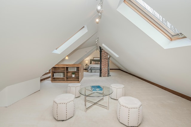 additional living space featuring vaulted ceiling with skylight and carpet flooring