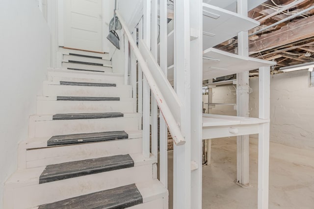 staircase with concrete flooring