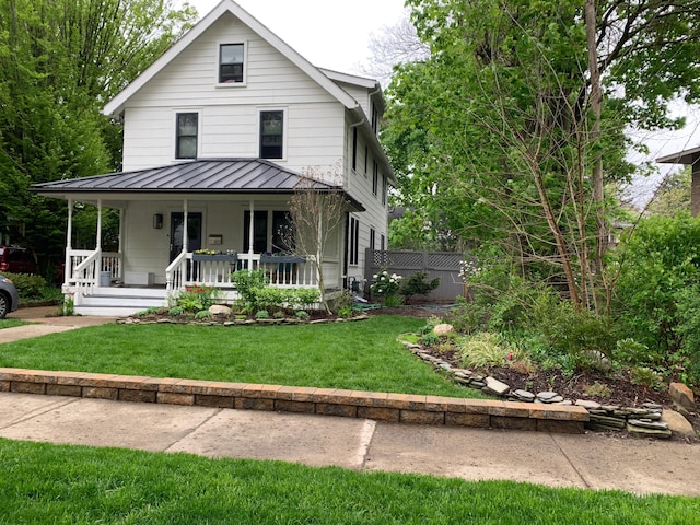 view of front facade with covered porch and a front yard