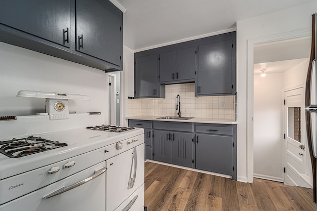 kitchen with dark hardwood / wood-style floors, sink, and backsplash