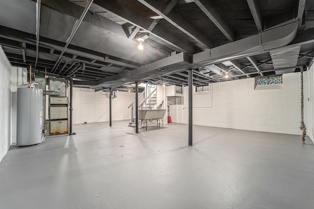 basement featuring water heater and heating unit