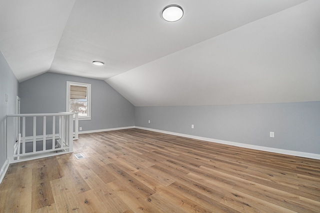 bonus room featuring vaulted ceiling and light wood-type flooring